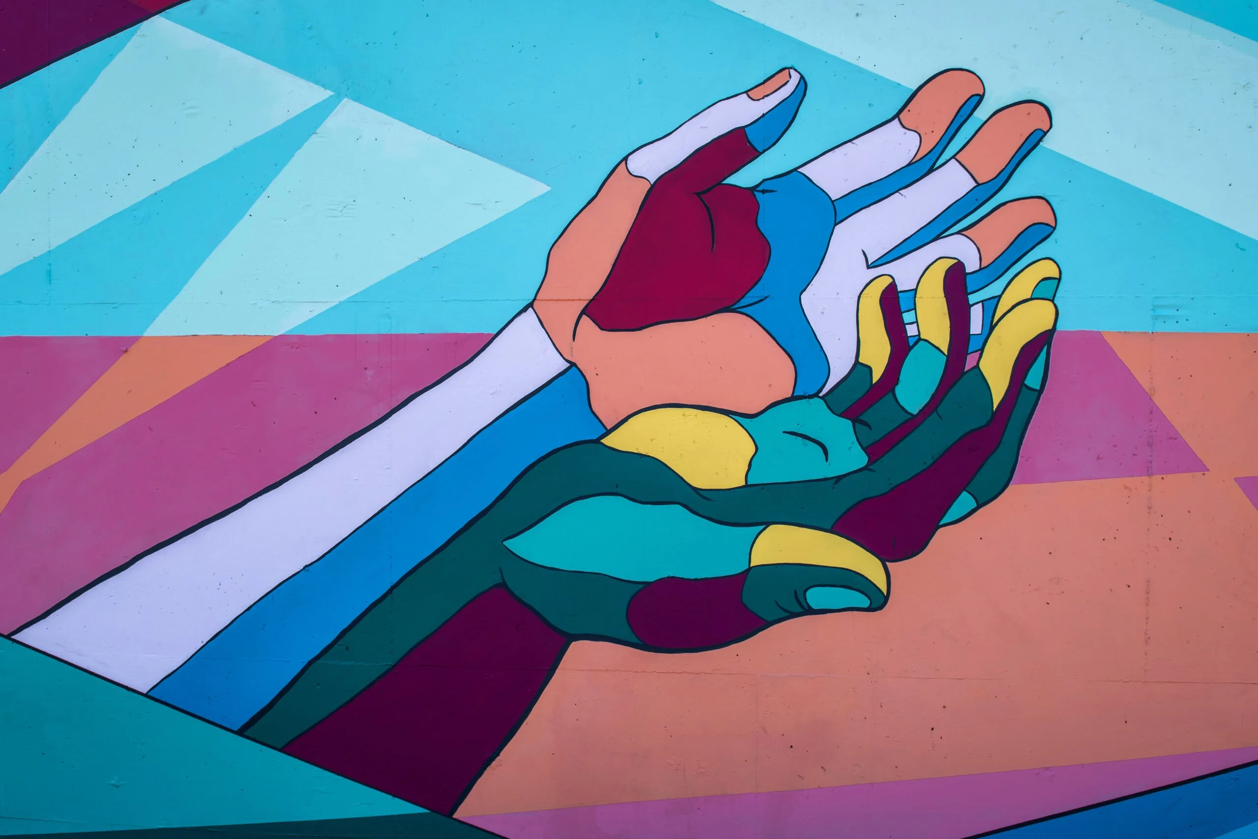 A vibrant painting of two hands reaching out to each other, showcasing the beauty of human connection.